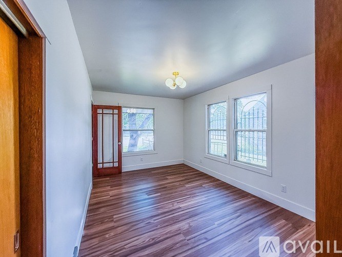 A room with wooden floors and a ceiling light.