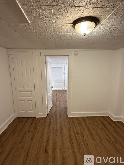 A room with wooden floors and a white door.
