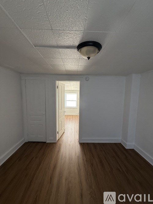 A room with wooden floors and a white door.