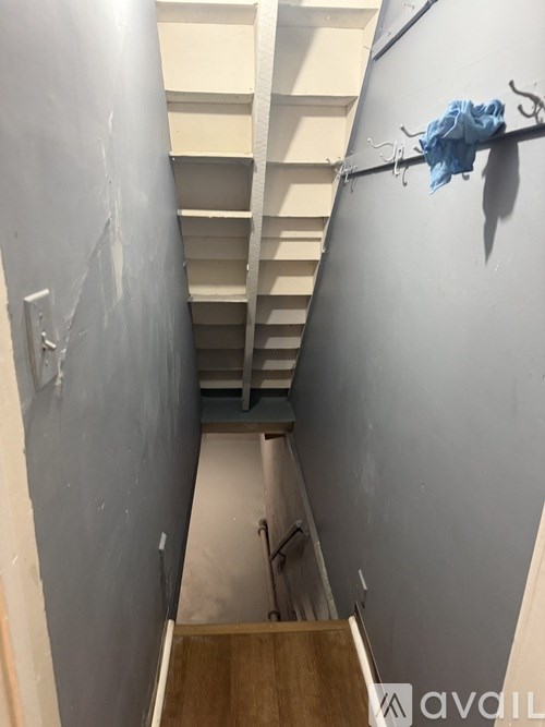 A stairway with a blue cloth hanging on the railing.