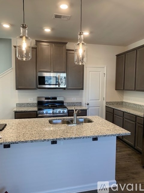 A kitchen with granite countertops and a sink.