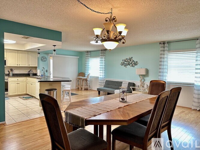 A dining room with a wooden table and chairs.