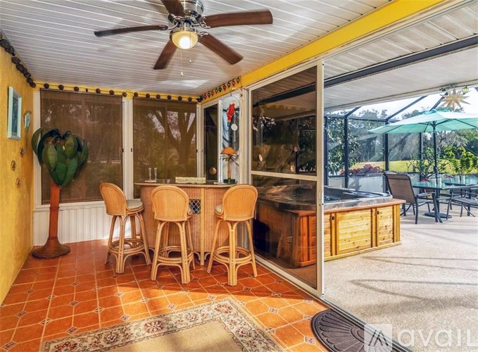A patio with a bar and chairs is shown.