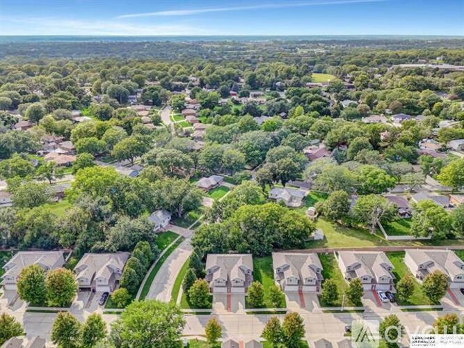 A bird's eye view of a residential neighborhood with houses and trees.