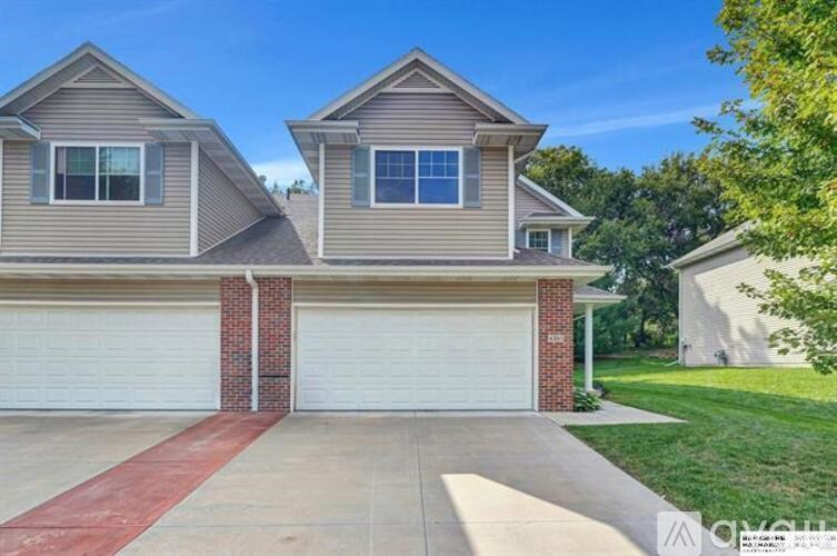 A two-story house with a garage is shown in the image.