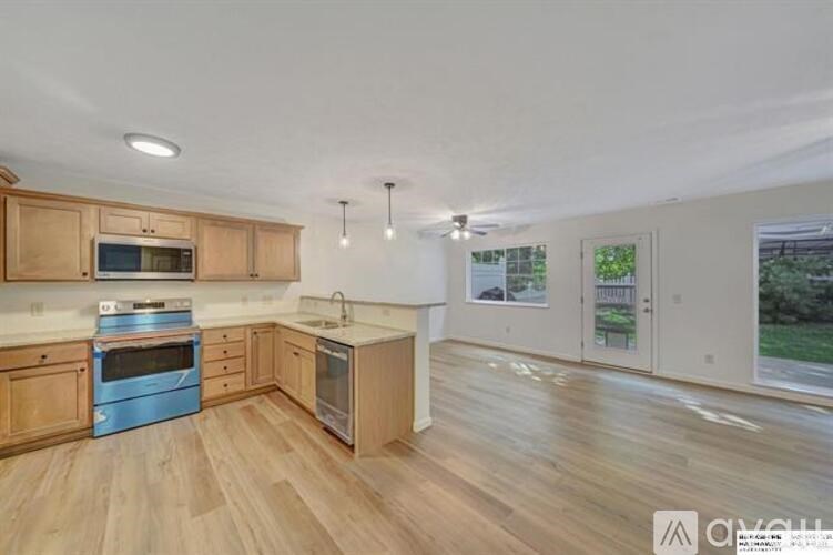 A kitchen with wooden cabinets and a blue oven.