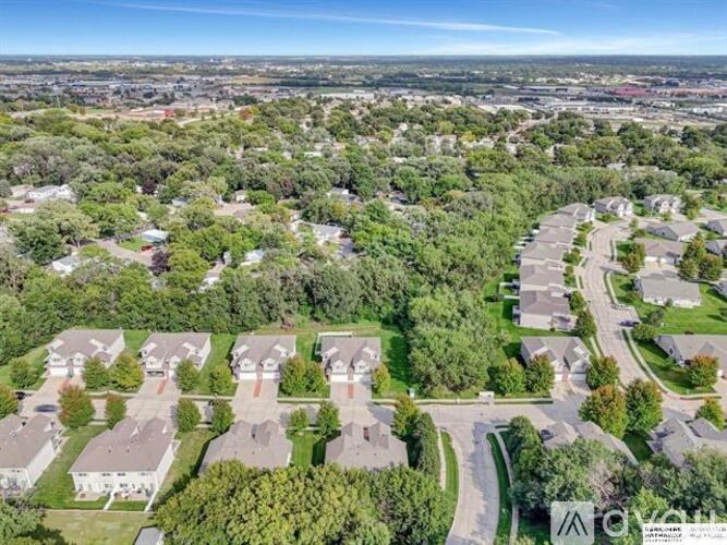 A bird's eye view of a residential neighborhood with houses and trees.