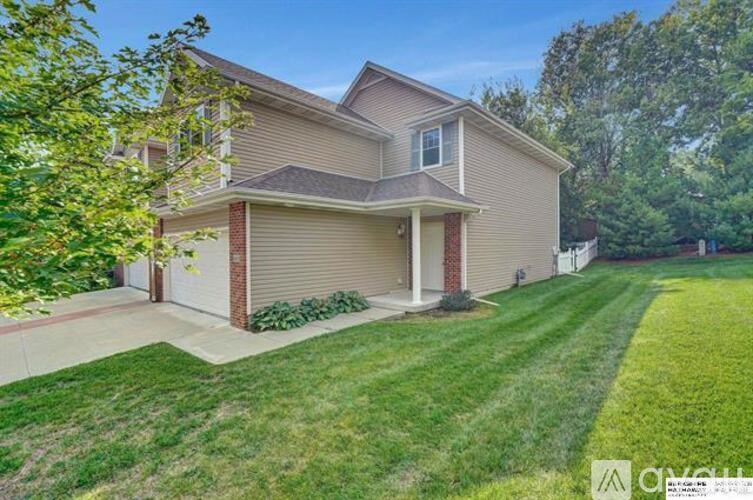 A house with a well-maintained lawn in front.