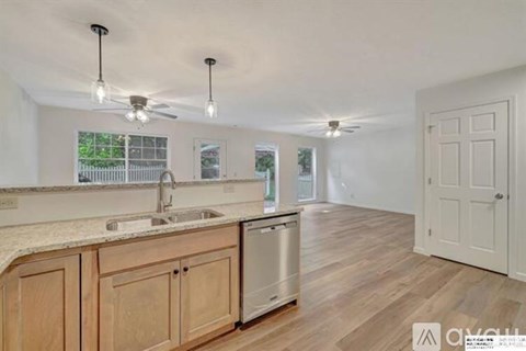A kitchen with wooden cabinets and a marble countertop.