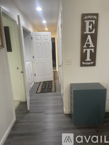A hallway with a sign that says "EAT" on the wall.
