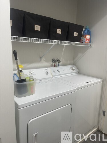 A white washing machine and dryer in a small laundry room.