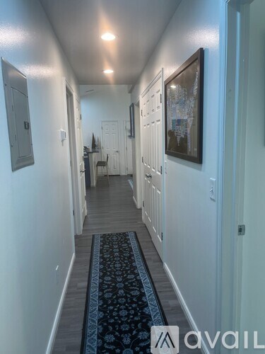 A hallway with a blue runner on the floor.