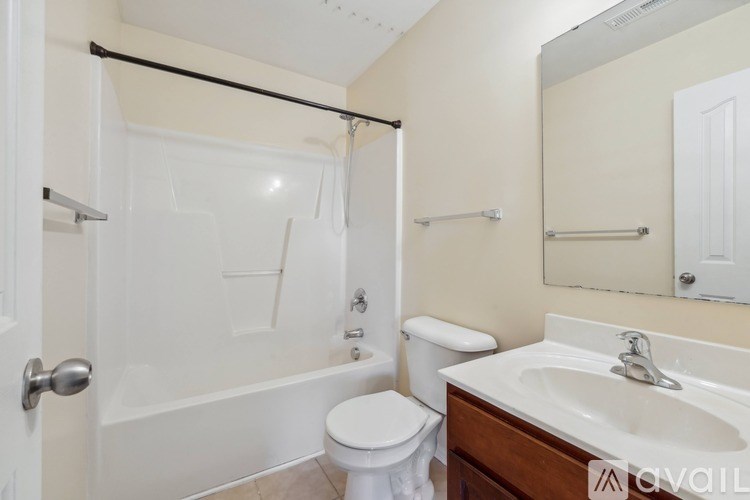 A white toilet sits next to a sink in a bathroom.