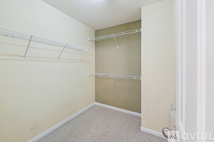 Empty room with white walls and a carpeted floor.