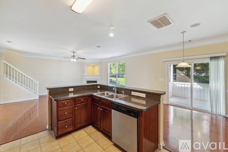 A kitchen with wooden cabinets and a stainless steel dishwasher.