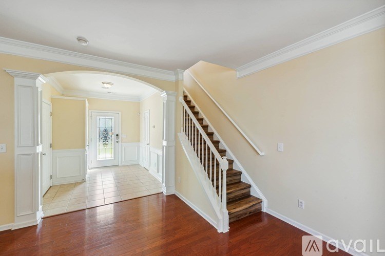 A hallway with a staircase leading to the second floor.