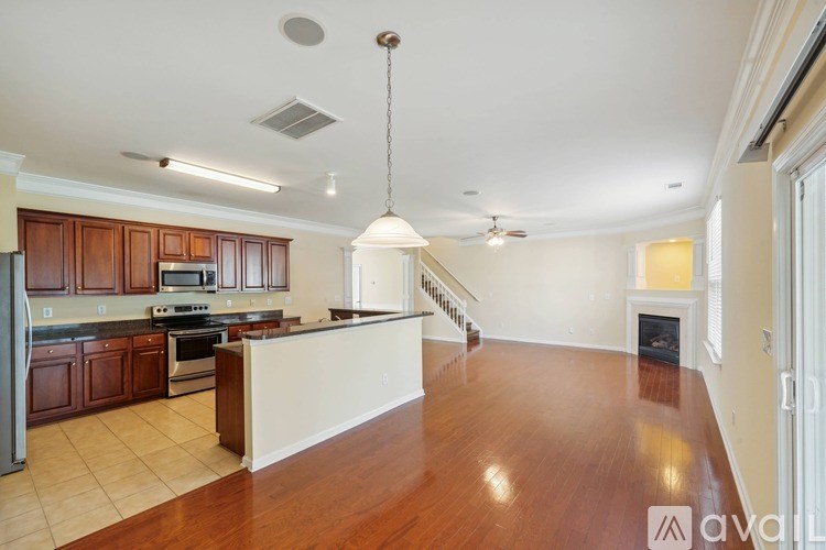 A kitchen with wooden floors and a white island.