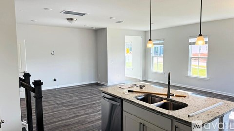 A kitchen with a sink and a window.
