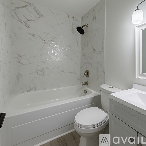 A bathroom with a marble wall and a white toilet.