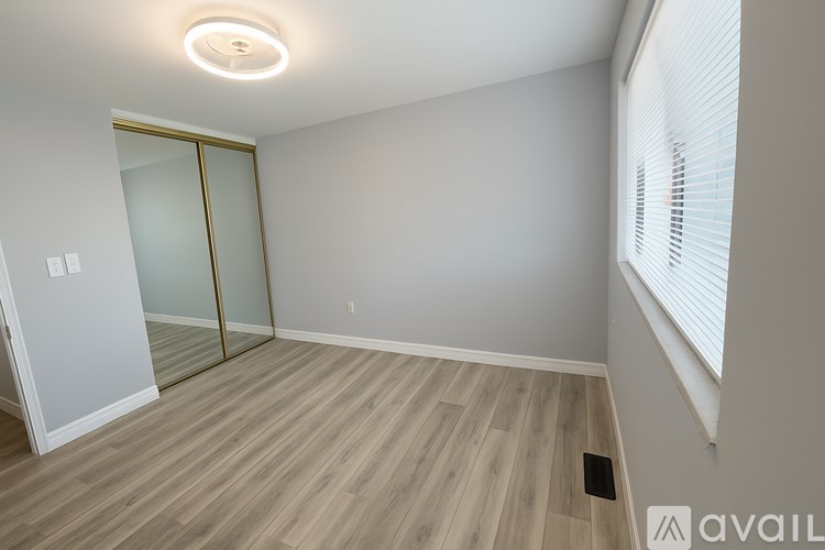 A room with a wooden floor and a glass door.