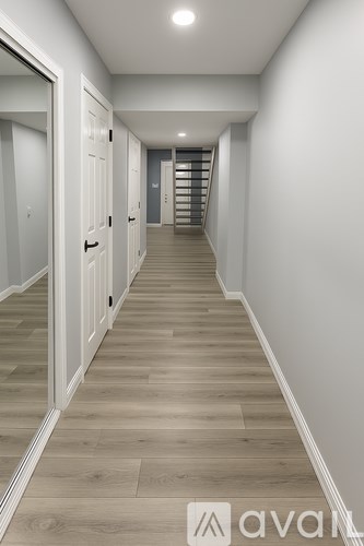 A long hallway with a staircase on the right side.