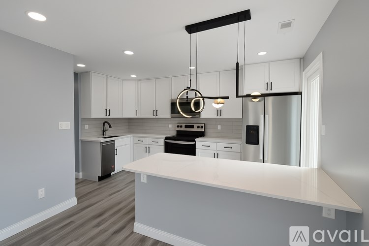A modern kitchen with a large island and stainless steel appliances.