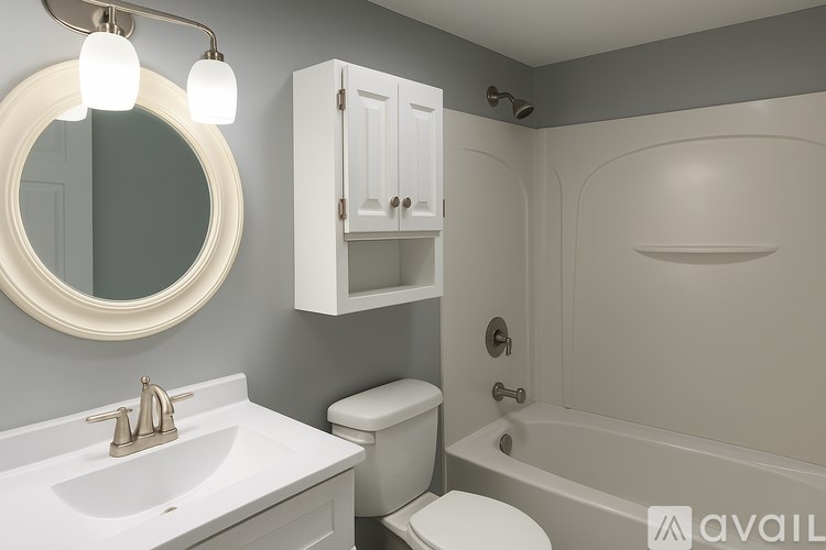 A bathroom with a white sink, toilet, and bathtub.