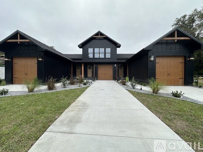 A black house with a brown door and windows.