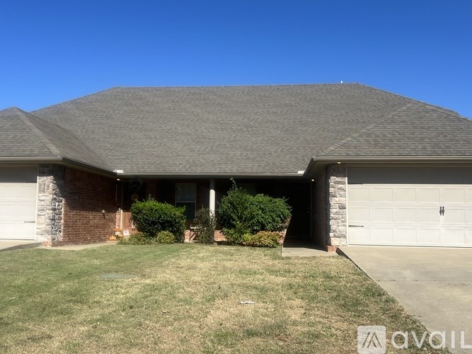 A house with a grey roof and a white garage door.