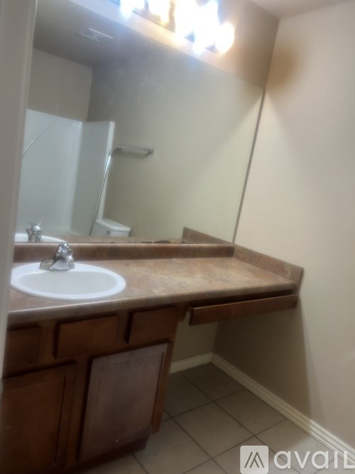 A bathroom with a sink and a mirror.