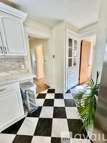 A kitchen with a black and white checkered floor.