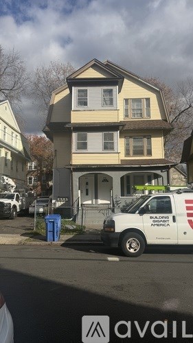 A two-story house with a van parked in front.