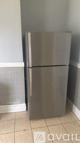 A stainless steel refrigerator in a kitchen.