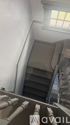 A staircase with a metal railing and steps leading upwards.