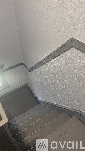 A staircase with a metal railing and steps leading upwards.