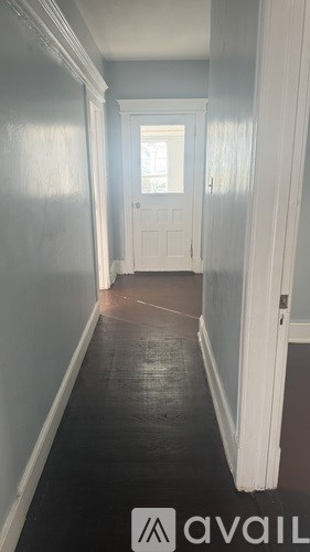 A long hallway with a door at the end.