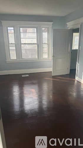 A room with a wooden floor and a white door.