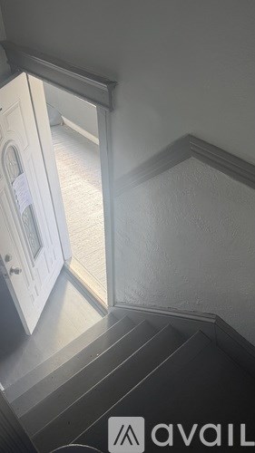 A white door is open to a hallway.