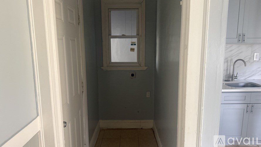 A room with a window and a door.