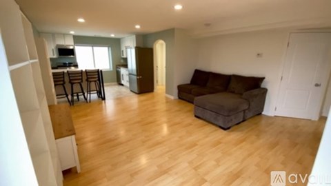 A living room with a couch and a dining table.