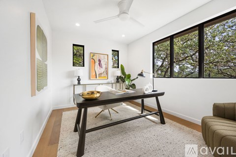A living room with a black table and a couch.