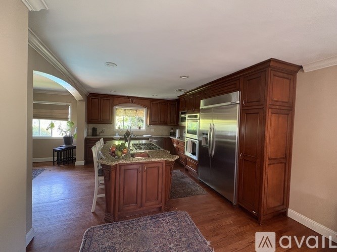 A kitchen with wooden cabinets and a granite countertop.