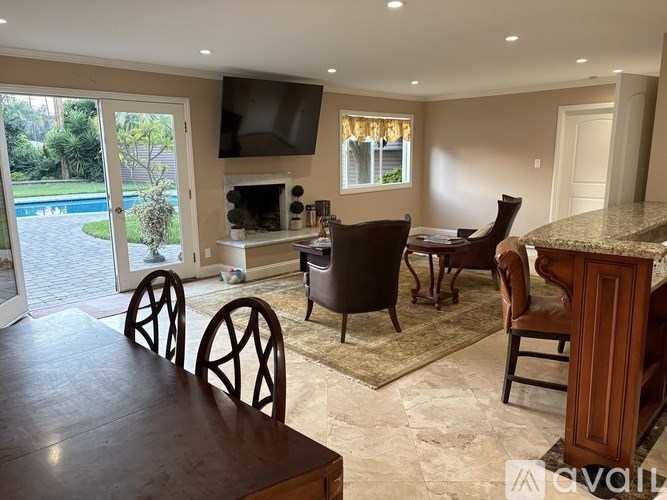 A dining room with a table and chairs.