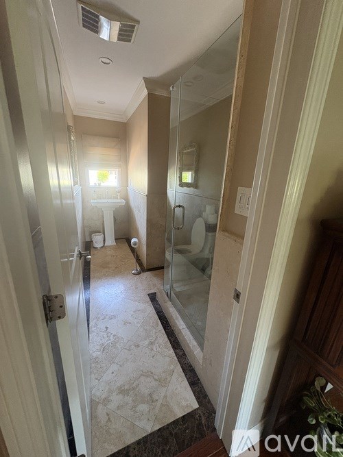 A bathroom with a walk-in shower and a toilet.