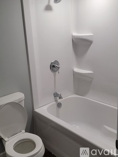 A white toilet is next to a white bathtub in a bathroom.