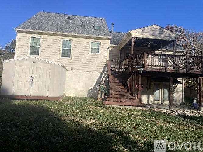 A house with a white garage door and a deck.