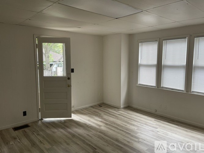 A room with a door and windows.