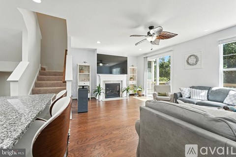 A living room with a grey couch and a marble counter top.