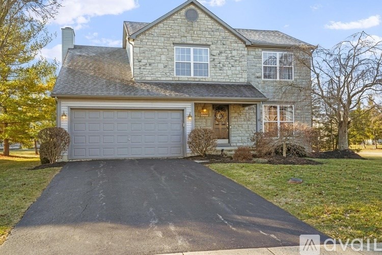 A house with a grey garage door is for sale.