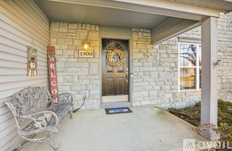 A house numbered 1500 with a wooden door and a wreath on it.